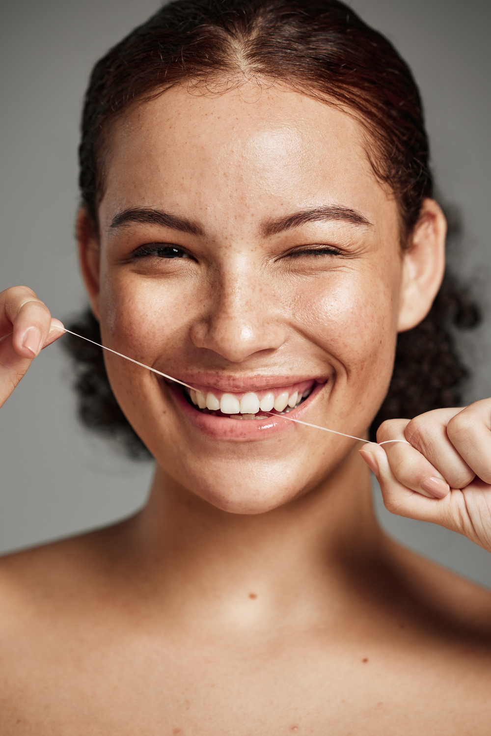 Teeth flossing, dental floss and portrait of woman with a smile in studio for oral hygiene, health .