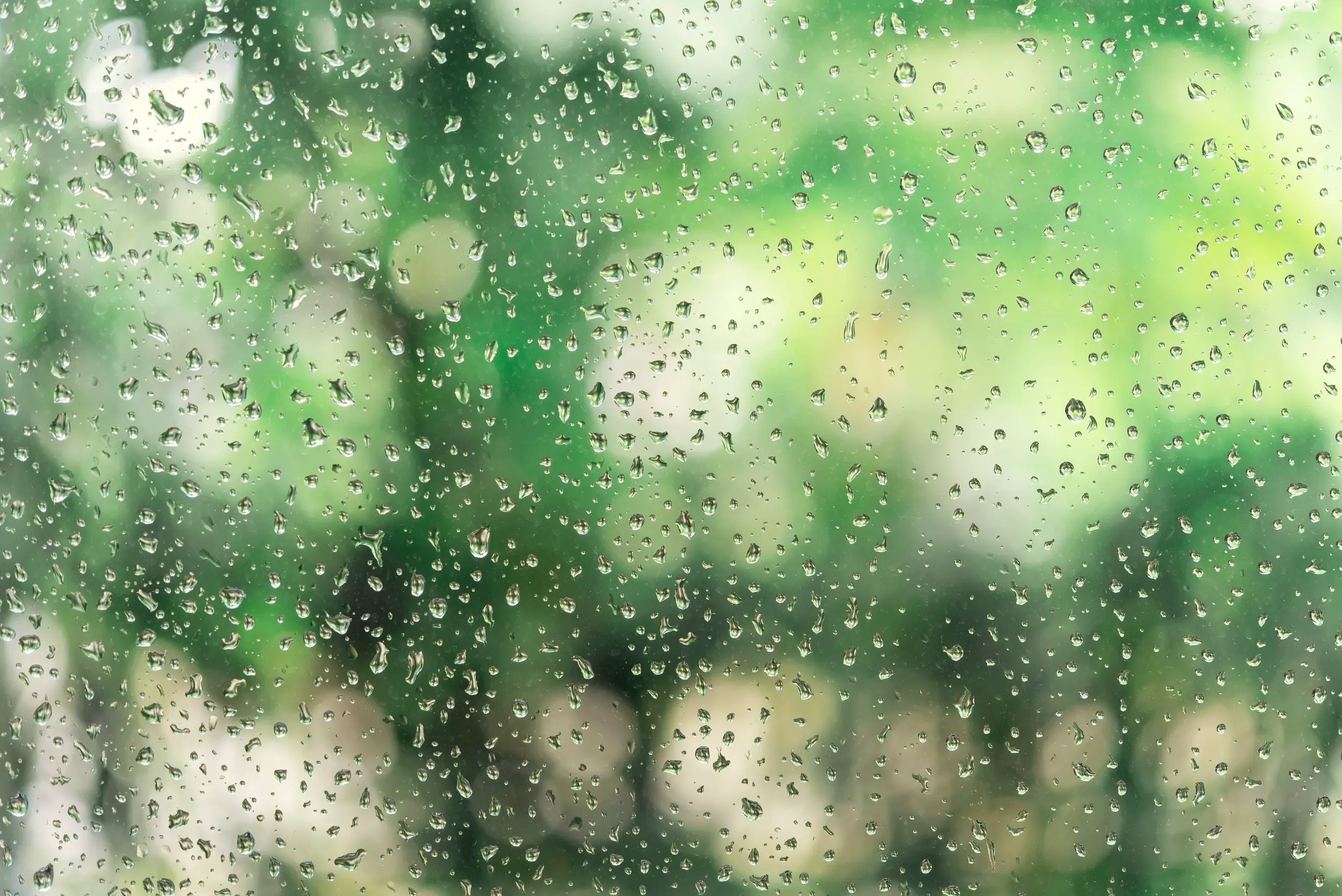 Featured image. Nature background with drops of rain on a glass.